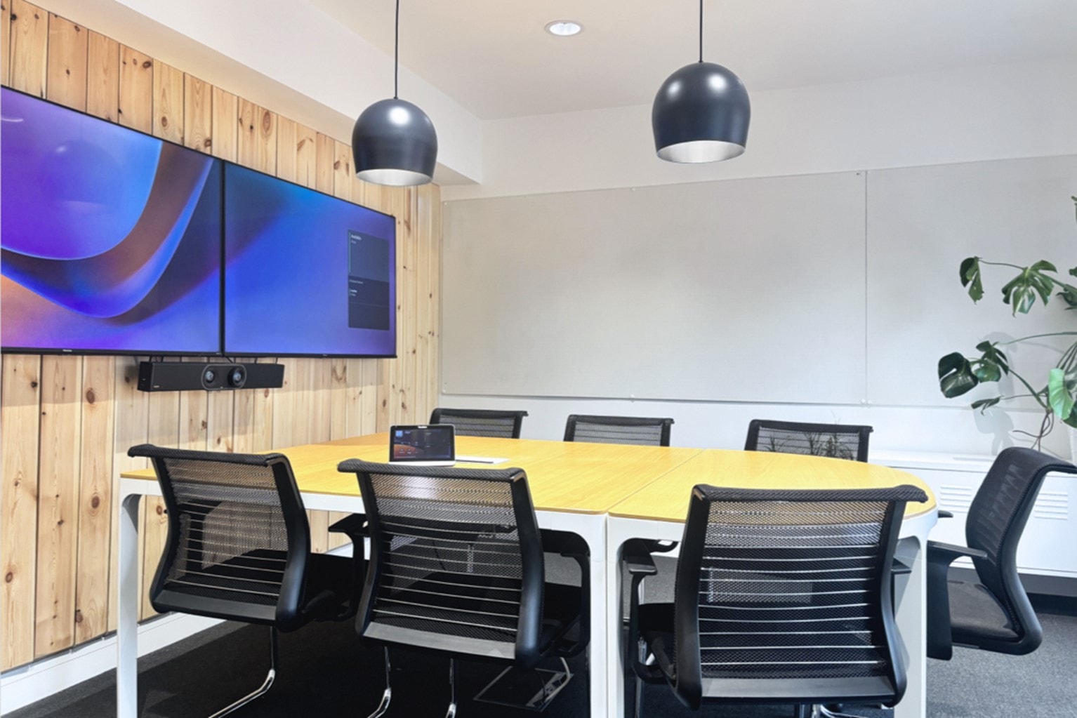 The Collaboration Space, duel monitors, desk and chairs, and whiteboards.